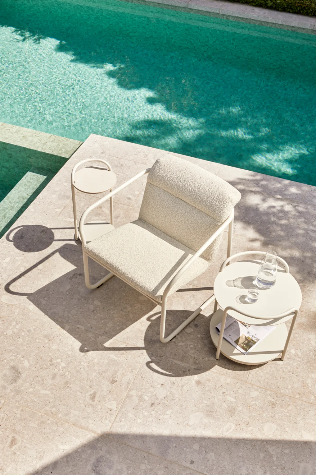 Recycled boucle outdoor seating in minimalist poolside setting