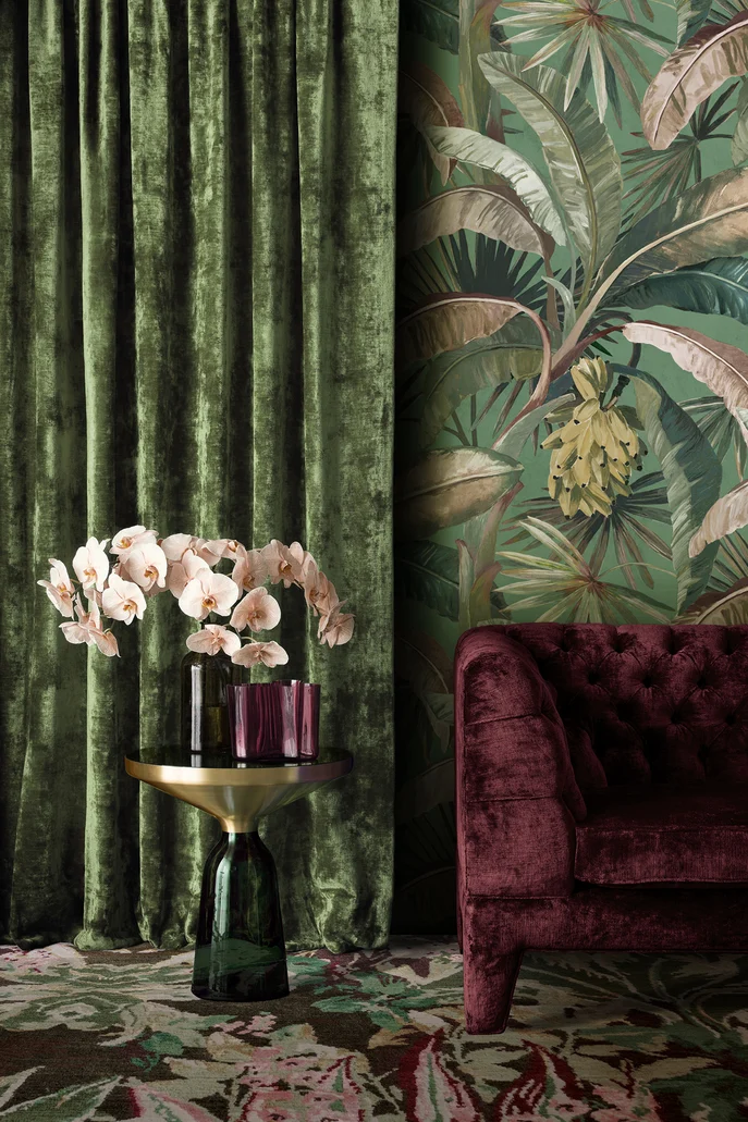 Tropical interior featuring velvet drapes and sofa