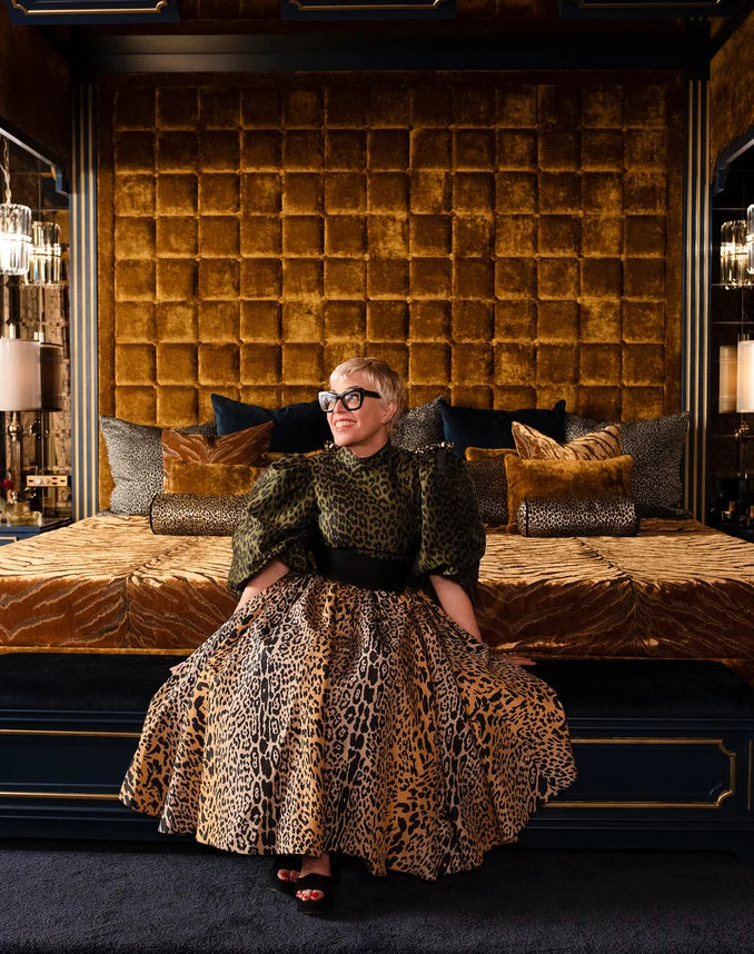 Bedhead in Bespoke colour Topaz, bedcover in Bengal Tiger colour Gold, cushions in Leopardo colour Tobacco, Bengal Tiger colour Gold, Bespoke colour Topaz, and Monarque colour Aquamarine | Catherine Martin in the Las Vegas Hotel Suite on set of Elvis | Photograph by Hugh Stewart