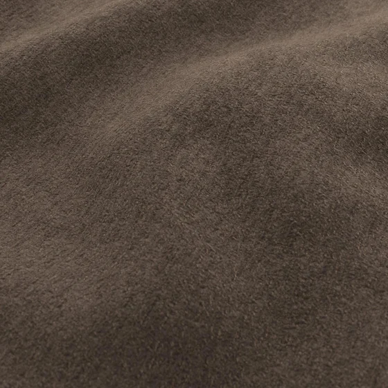 Photo of the fabric Snugly Chocolate swatch by James Dunlop FibreGuard. Use for Upholstery, Accessory, Top of Bed. Style of Chenille, Plain