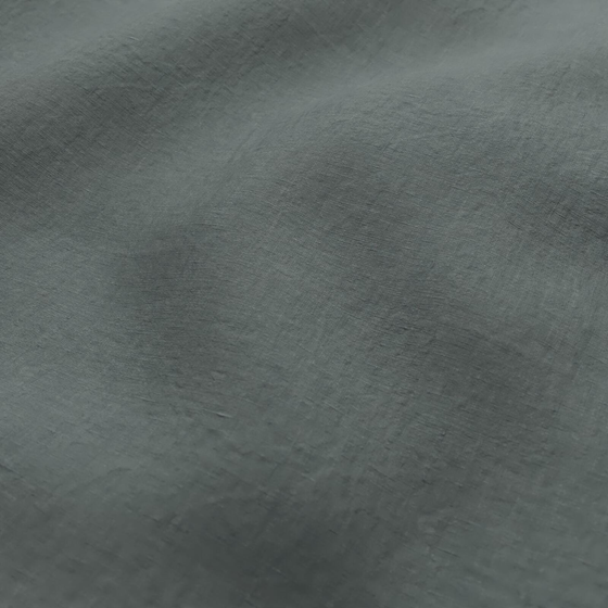 Photo of the fabric Satori Stonewash Teal swatch by Mokum. Use for Curtains, Upholstery Light Duty, Accessory, Top of Bed. Style of Plain, Texture