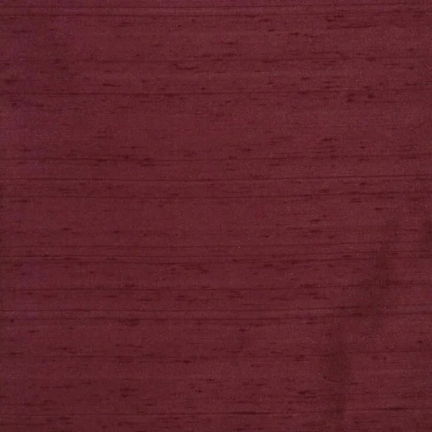 Photo of the fabric Luxe Garnet swatch by James Dunlop Essentials. Use for Curtains, Accessory, Top of Bed. Style of Plain, Texture