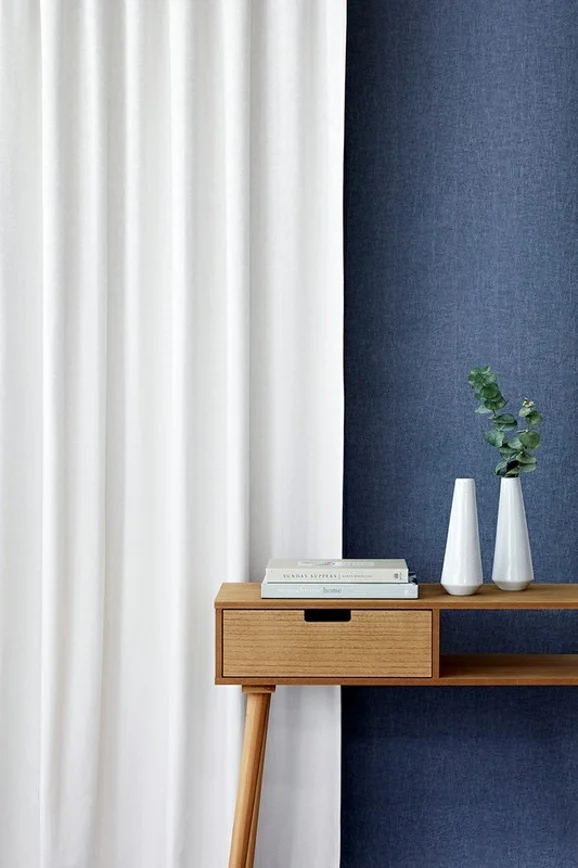 Photo of the fabric Avalon FR Blackout Steel in situ by James Dunlop Essentials. Use for Curtains. Style of Plain, Texture
