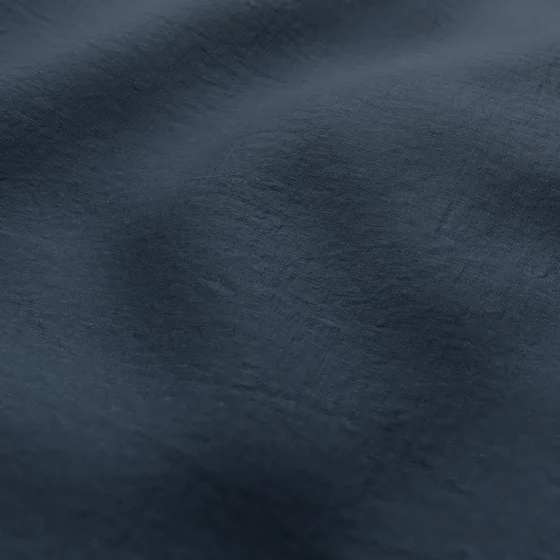 Photo of the fabric Satori Stonewash Ink swatch by Mokum. Use for Curtains, Upholstery Light Duty, Accessory, Top of Bed. Style of Plain, Texture