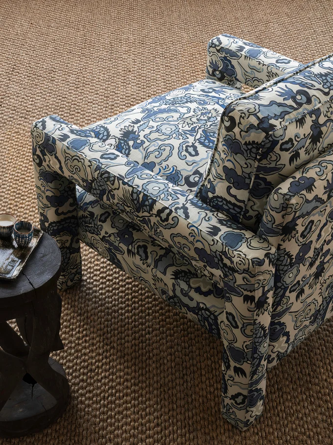 Interior setting featuring dragon print upholstered chair in traditional Chinese colours