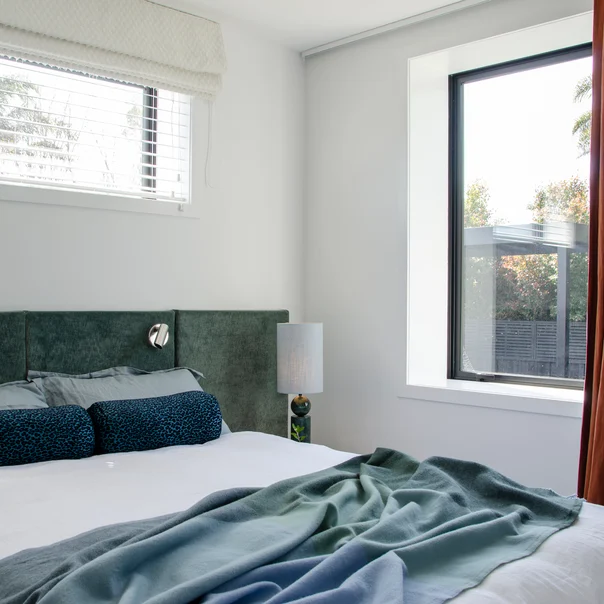 Headboard in Rough colour Chinois Green by James Dunlop, bolsters in Leopardo colour Sapphire by Catherine Martin by Mokum, curtain in Eternal colour Burnt Orange by Mokum, and Roman blind in Reminisce colour Calm by James Dunlop | Images: Matt South Designer