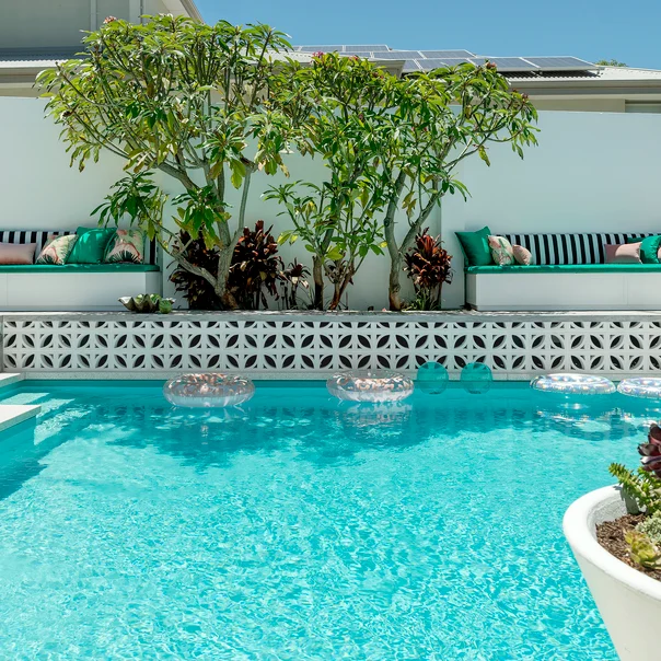 Squabs in South Beach by Mokum colour Emerald, scatter cushions in South Beach by Mokum colours Emerald and Flamingo, and Tropicalia by Catherine Martin by Mokum colour Coral