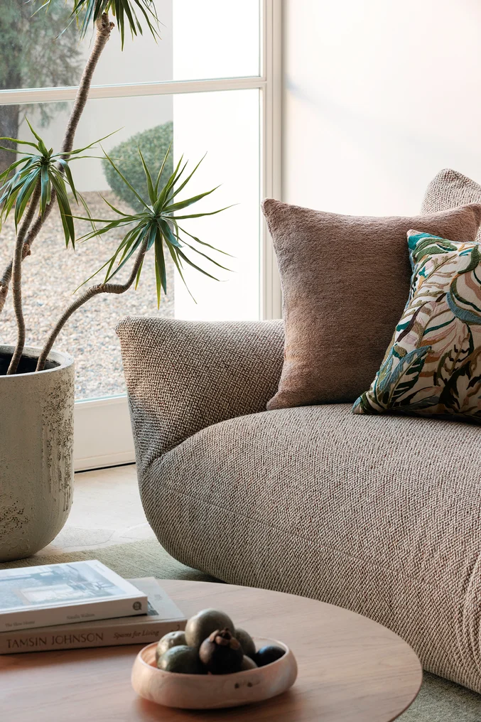 Sofa in Vomo colour Lava, cushions in Modernist colour Blush and Cordia colour Lagoon, all by Mokum