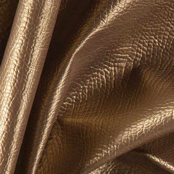Photo of the fabric Nashi Bronze swatch by Zepel. Use for Upholstery, Accessory, Top of Bed. Style of Leather And Vinyl, Plain