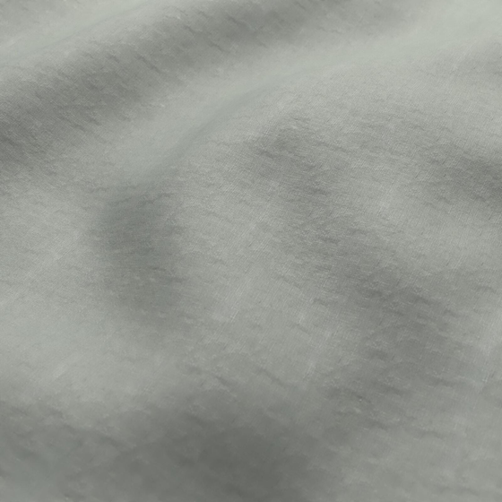 Photo of the fabric Satori Stonewash Willow swatch by Mokum. Use for Curtains, Upholstery Light Duty, Accessory, Top of Bed. Style of Plain, Texture