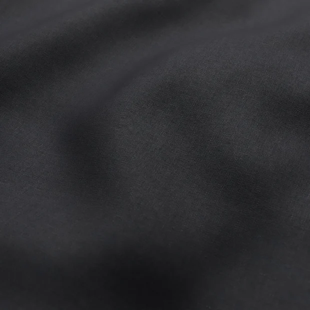 Photo of the fabric Kanvas Ebony swatch by Zepel FibreGuard. Use for Curtains, Upholstery, Accessory, Top of Bed. Style of Plain, Taffeta