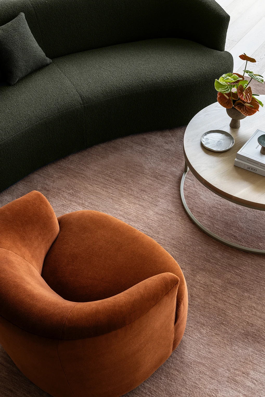 Sofa in Grande Boucle colour Martini & chair in Alpaca Velvet colour Burnt Orange by Mokum