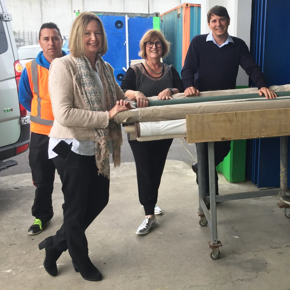 From left: Jason and Sue from James Dunlop Textiles, Janene from Guthrie Bowron and Conrad from Habitat for Humanity with just a few of the rolls.
