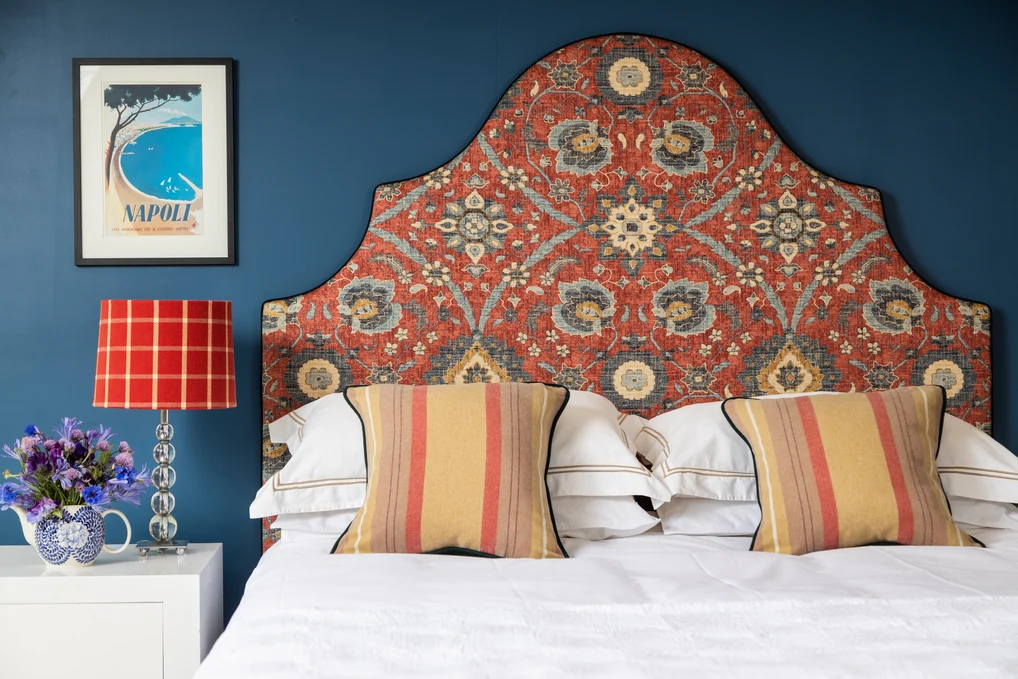 Mulberry Bedhead in Alexander, Scarlet.
Valance in Como, Ink with insets of Prato, Emerald.
Cushions in Loch, Cardinal and Prato, Emerald.
Lampshade in Haddington, Cardinal.