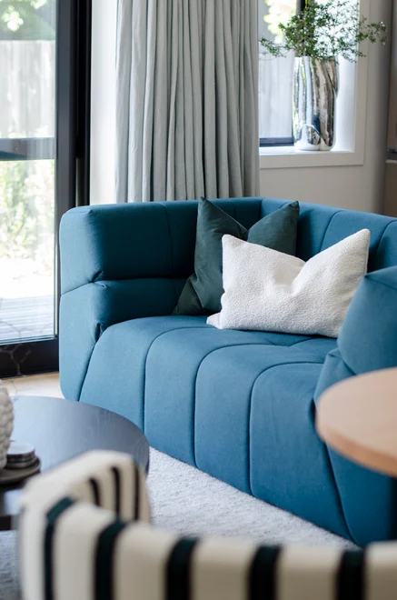 Sofa in Como colour Teal by Mokum, white cushion in Grand Boucle colour Silk by Catherine Martin by Mokum, and curtain in Linen colour Mist by James Dunlop | Images: Matt South Designer