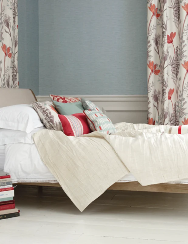Photo of the fabric Bloom Saffron in situ by James Dunlop. Use for Curtains, Upholstery Light Duty, Accessory, Top of Bed. Style of Floral And Botannical, Print