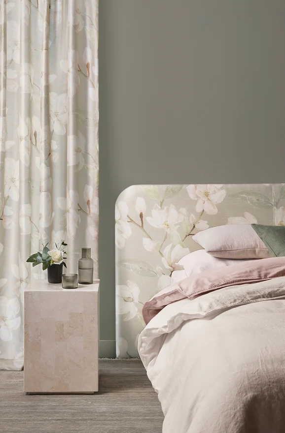 Photo of the fabric Maharani Blush in situ by James Dunlop. Use for Curtains, Upholstery Light Duty, Accessory, Top of Bed. Style of Floral And Botannical