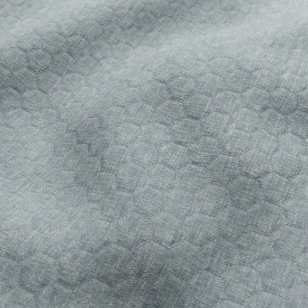 Photo of the fabric Colourquilt Aqua swatch by Zepel FibreGuard. Use for Upholstery, Accessory, Top of Bed. Style of Embroidery, Geometric