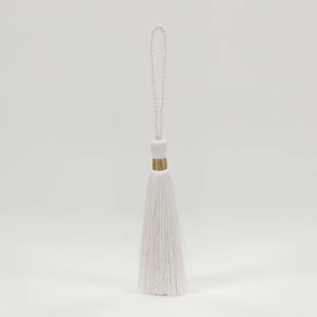 Photo of the fabric Key Tassel T121 03 swatch by Romo. Use for Trim