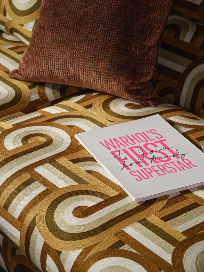 Retro-inspired crewel embroidery upholstery on sofa