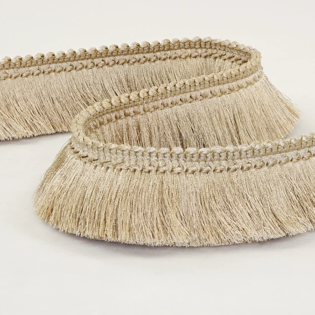 Photo of the fabric Brush Fringe T120 08 swatch by Romo. Use for Trim