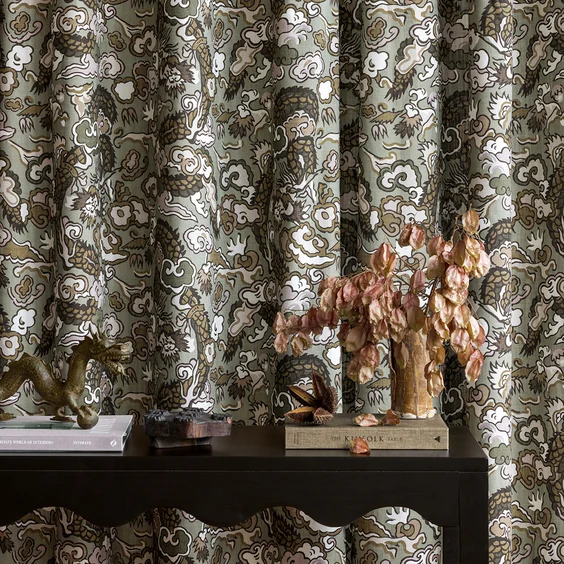 Interior setting featuring dragon print drapes behind console table