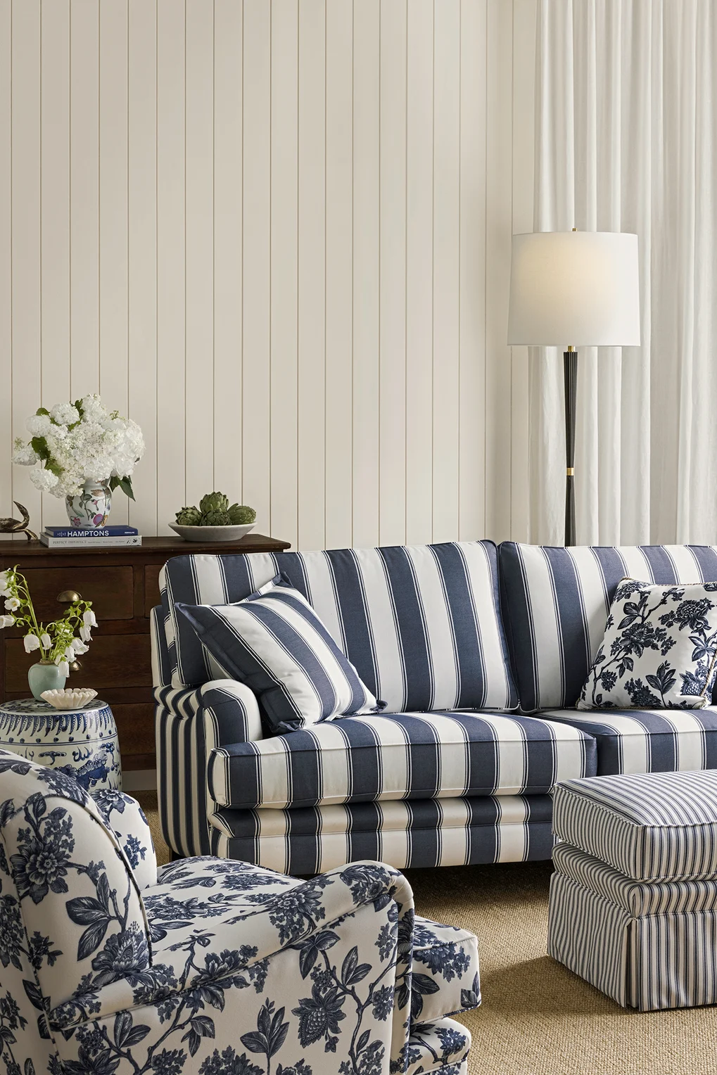Vertical broad stripe upholstered sofa in traditional interior setting