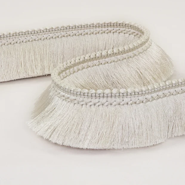 Photo of the fabric Brush Fringe T120 09 swatch by Romo. Use for Trim